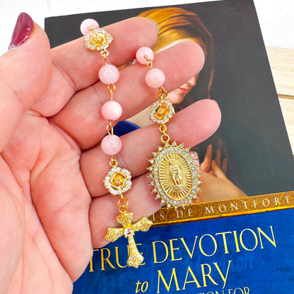 Luxury Catholic rosary bracelet handcrafted with natural rose quartz gemstone beads, a gold-tone cross with zirconia accents, and a Lady of Guadalupe medal. Adjustable beaded bracelet perfect for prayer, religious gifts, Confirmation, bridesmaid gifts, or everyday devotion. Made in Edmonton, AB, Canada.
