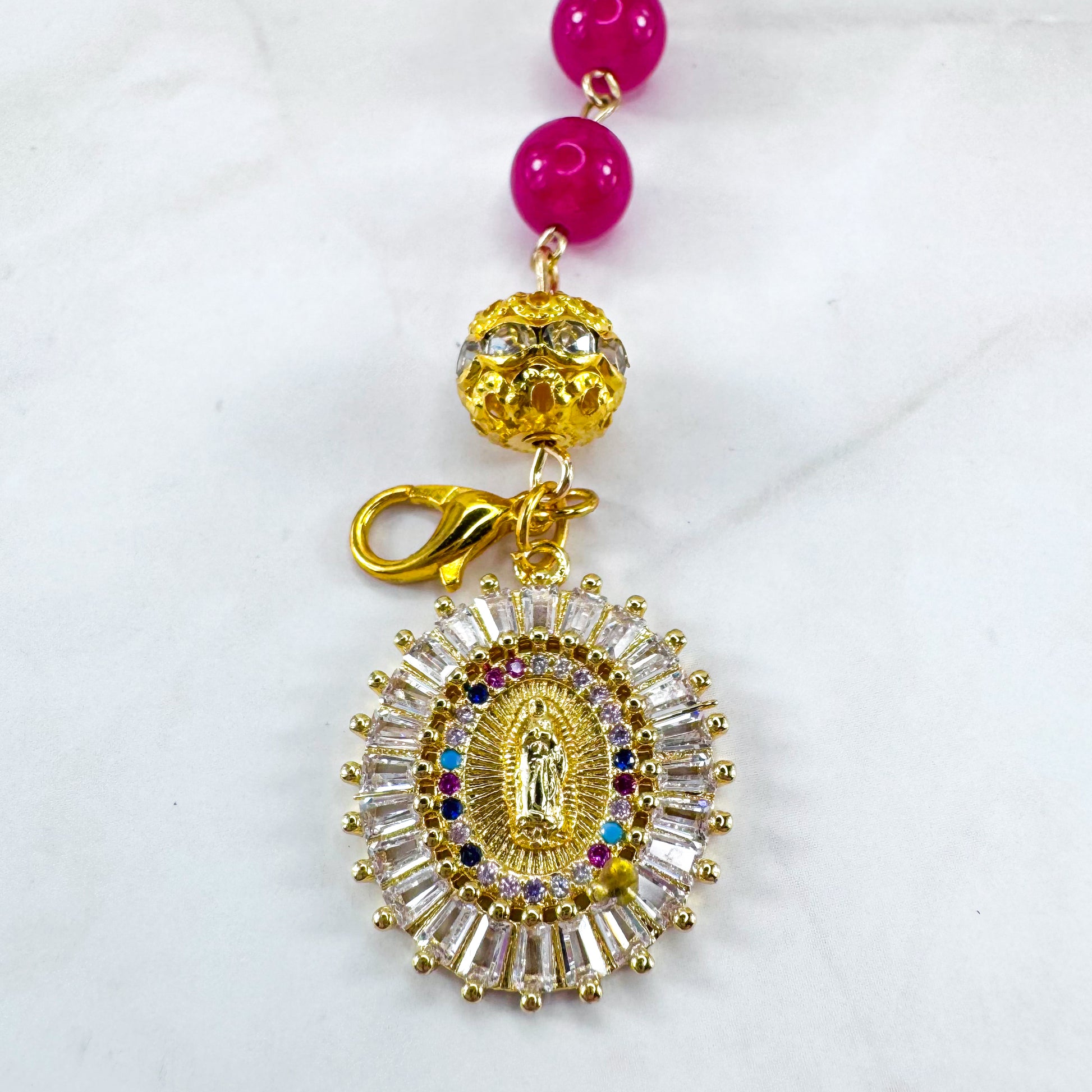 Luxury Catholic rosary bracelet handcrafted with natural Rose Red Chalcedony gemstone beads, a gold-tone cross with zirconia accents, and a Lady of Guadalupe medal. Adjustable beaded bracelet perfect for prayer, religious gifts, Confirmation, bridesmaid gifts, or everyday devotion. Made in Edmonton, AB, Canada.