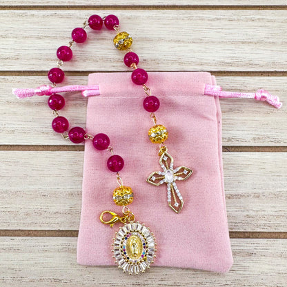 Luxury Catholic rosary bracelet handcrafted with natural Rose Red Chalcedony gemstone beads, a gold-tone cross with zirconia accents, and a Lady of Guadalupe medal. Adjustable beaded bracelet perfect for prayer, religious gifts, Confirmation, bridesmaid gifts, or everyday devotion. Made in Edmonton, AB, Canada.